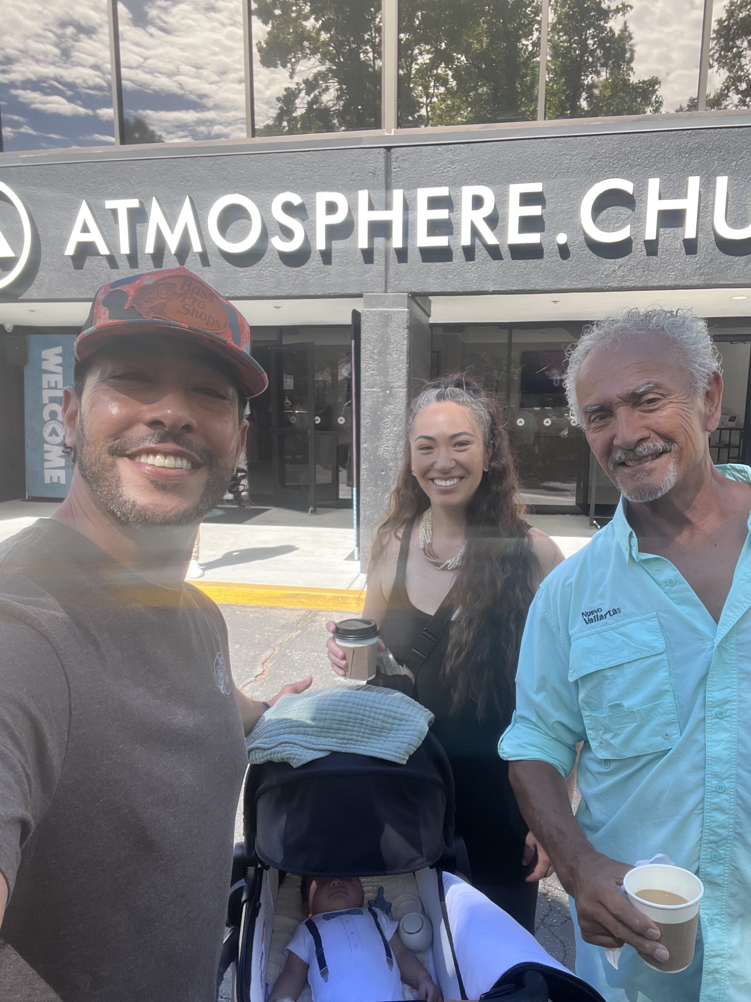 Dione with family and their baby outside church